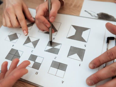 Hands point to and mark answers on a visual pattern test.