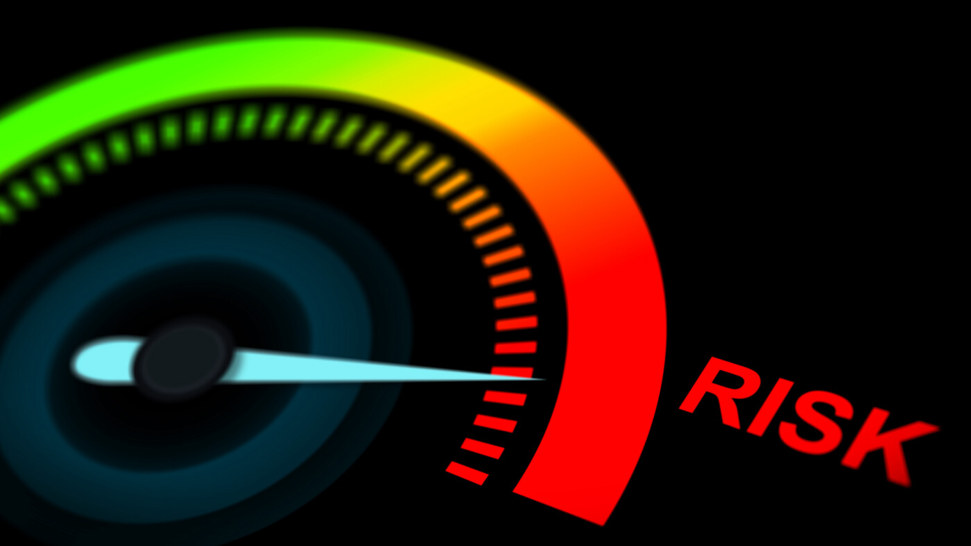 A risk gauge, with the needle pointing to a red zone of higher risk.