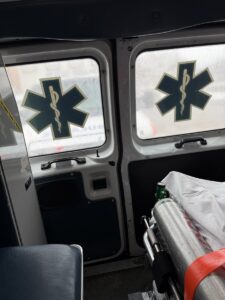 A photo of the inside of an ambulance, facing the back doors. Not much else is visible in the photo. 