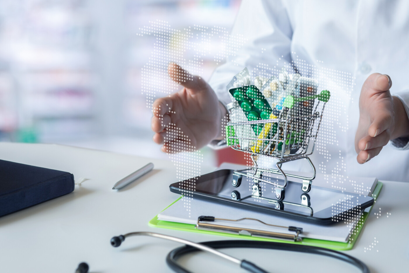 An image of medications in a miniature shopping cart on a tablet in front of a healthcare professional.
