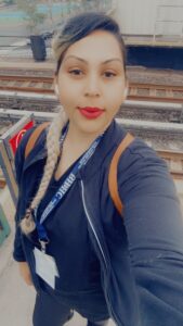 A woman in a work uniform takes a selfie.