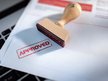 A wooden stamper is seen lying next to an 